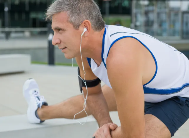 mature man stretching before outdoor exercise