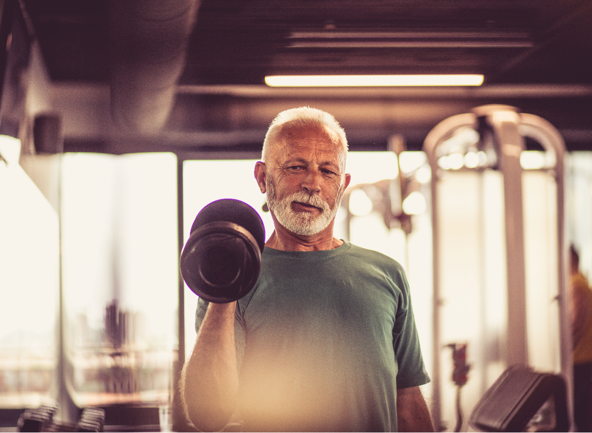 senior man exercising with weights to prevent bone loss