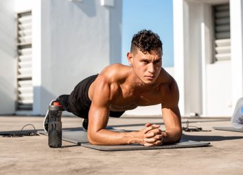 fit man performing plank outdoors