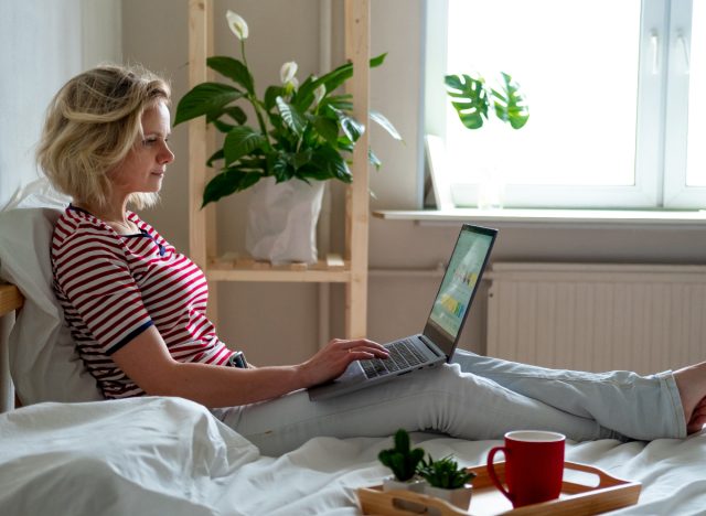 woman working from bed