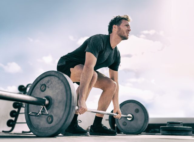 man lifting barbell