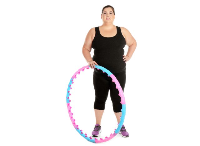 woman holding weighted hula hoop for workout