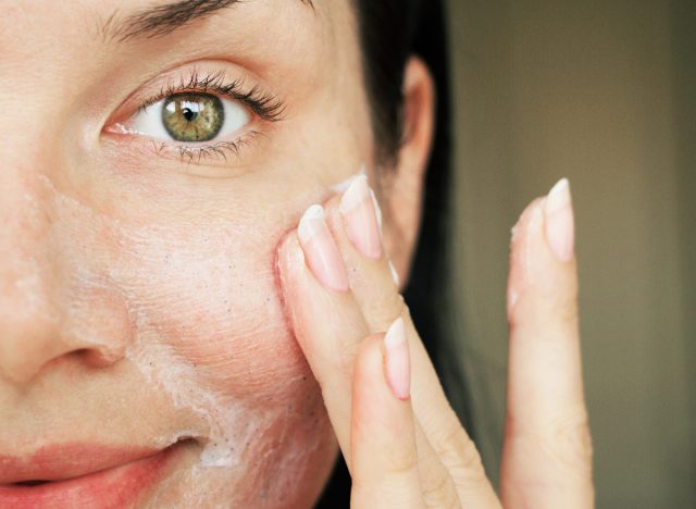 woman applying cleanser to wash face