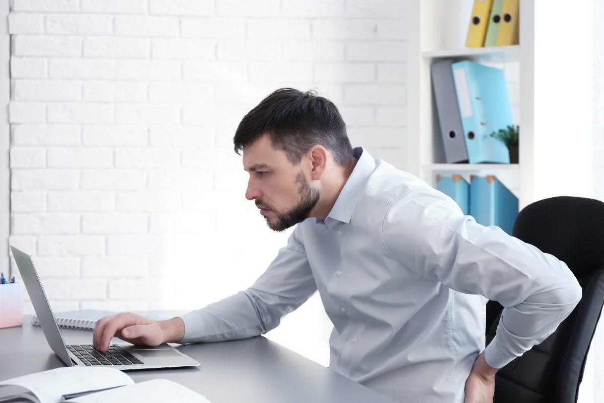 man dealing with back pain, bad posture