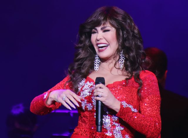 marie osmond performing in sparkly red gown