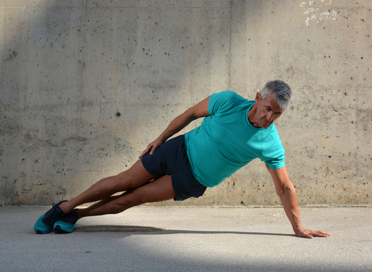 man in his 60s doing floor workout