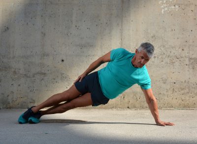 man in his 60s doing floor workout