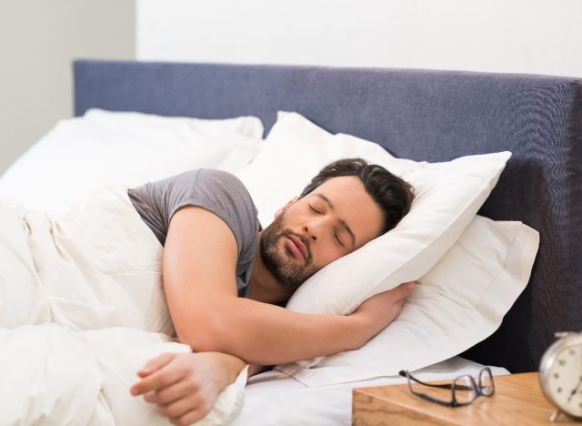 man sleeping in bright room