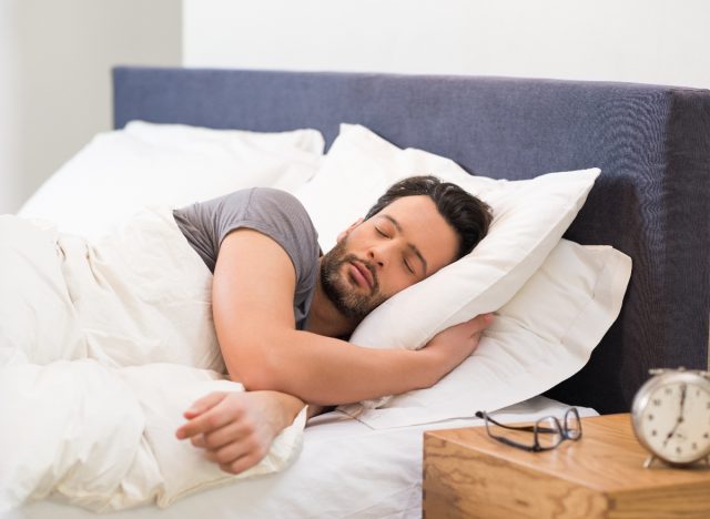 man sleeping in bright room