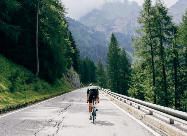 man doing hill climbers on his bike