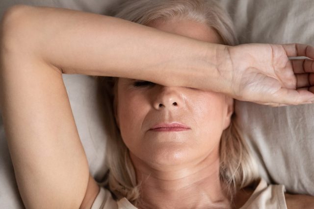 woman has trouble sleeping while dealing with menopause