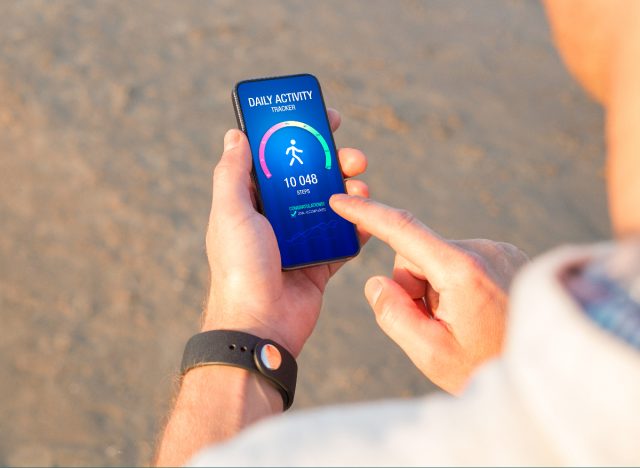 man counting steps on phone