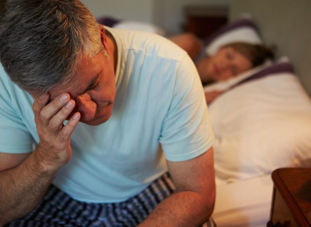 older man with insomnia wakes up at night