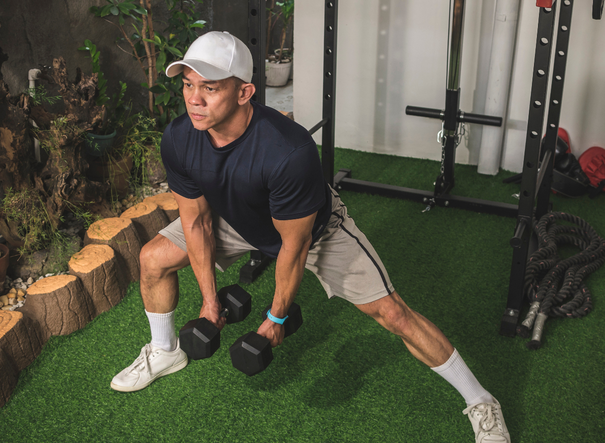 man performing lateral lunge with dumbbells