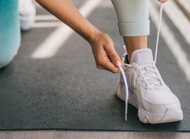 tying sneakers in gym