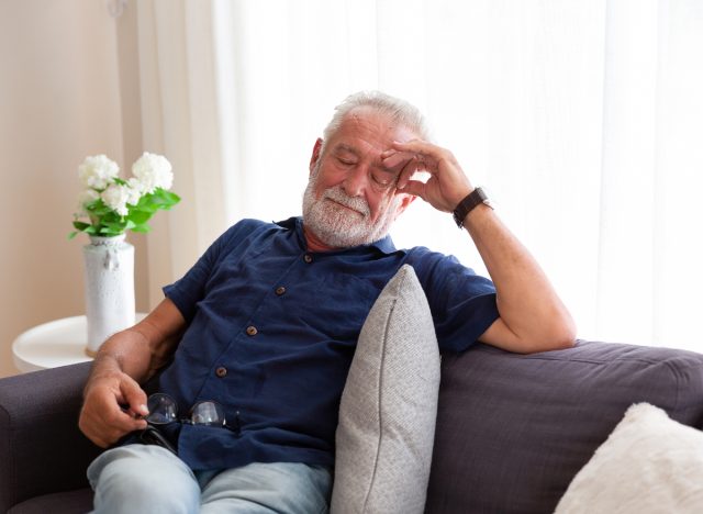 man taking afternoon nap on couch