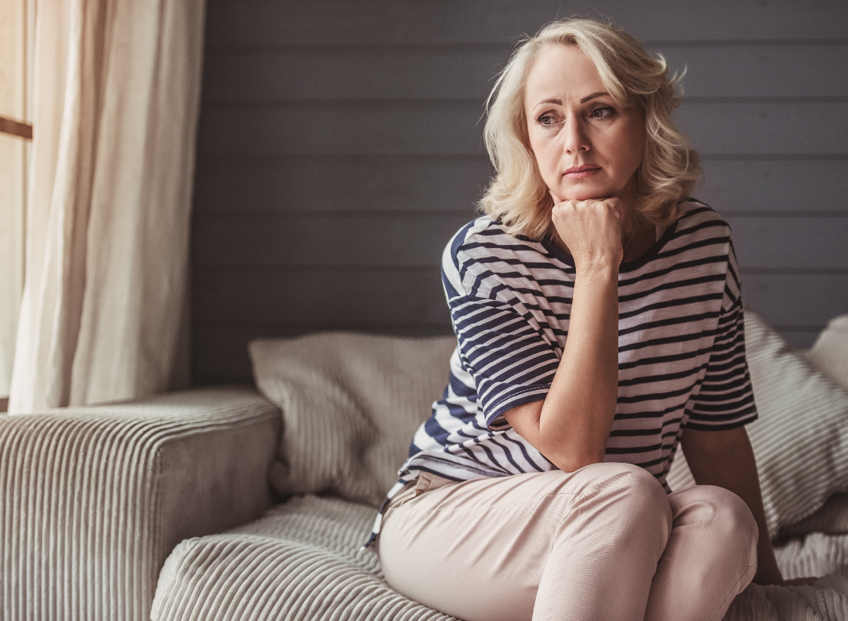 woman looking pensive on couch