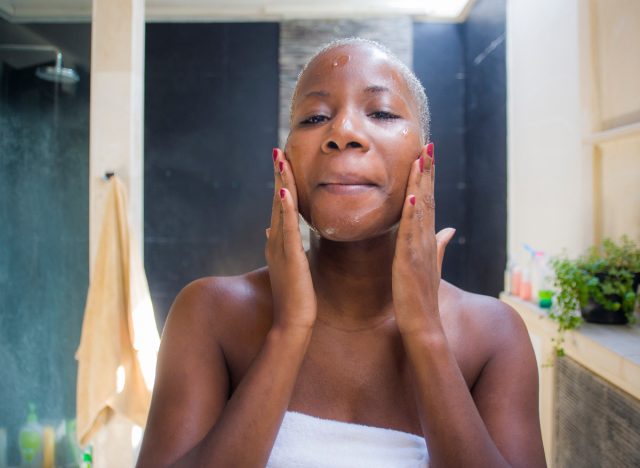 woman exfoliating her skin