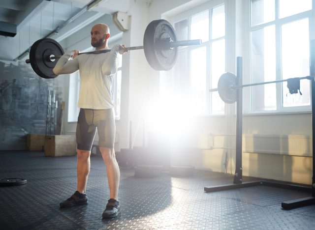 man doing barbell exercise in gym