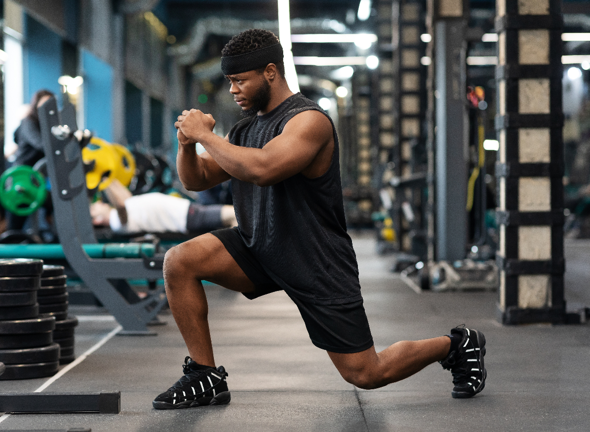 man doing front squat in gym