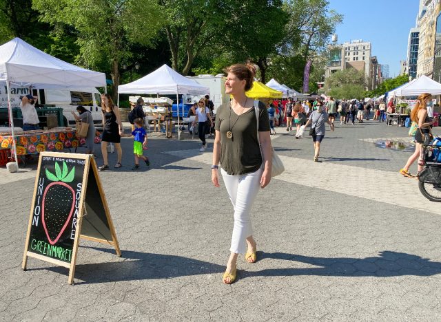 woman walking through a farmers market in NYC