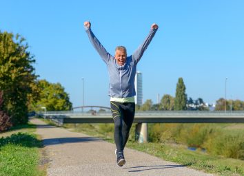 happy fit man walks after succeeding daily step goal