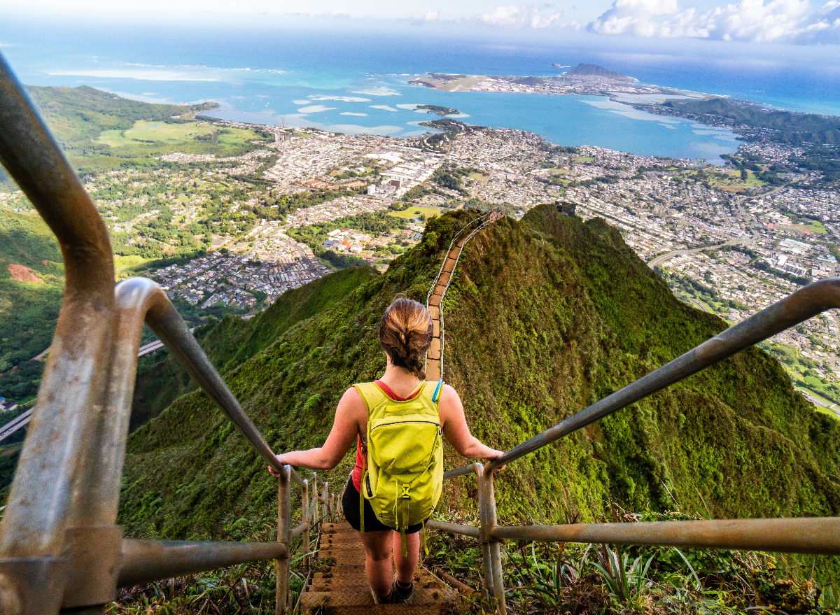 woman hikes down stairs in oahu, hawaii