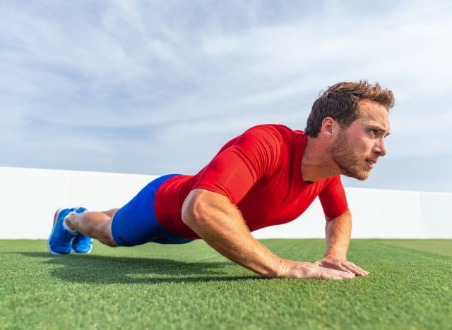 man doing diamond pushup on turf