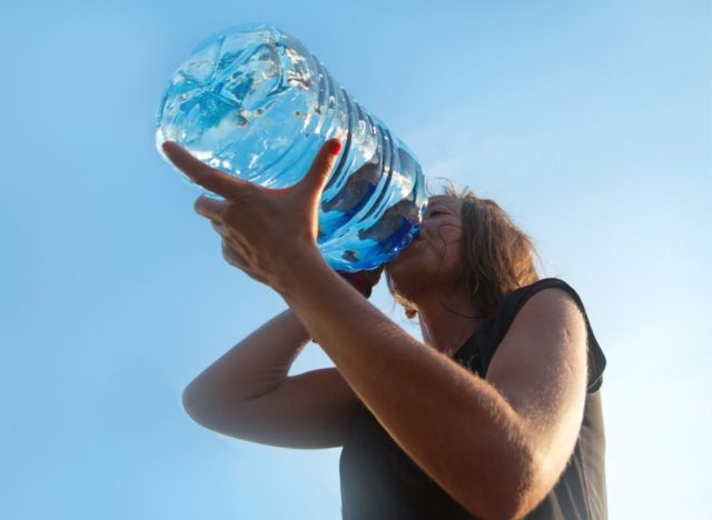 drinking big water bottle