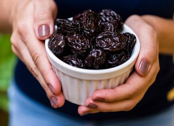 holding a bowl of prunes