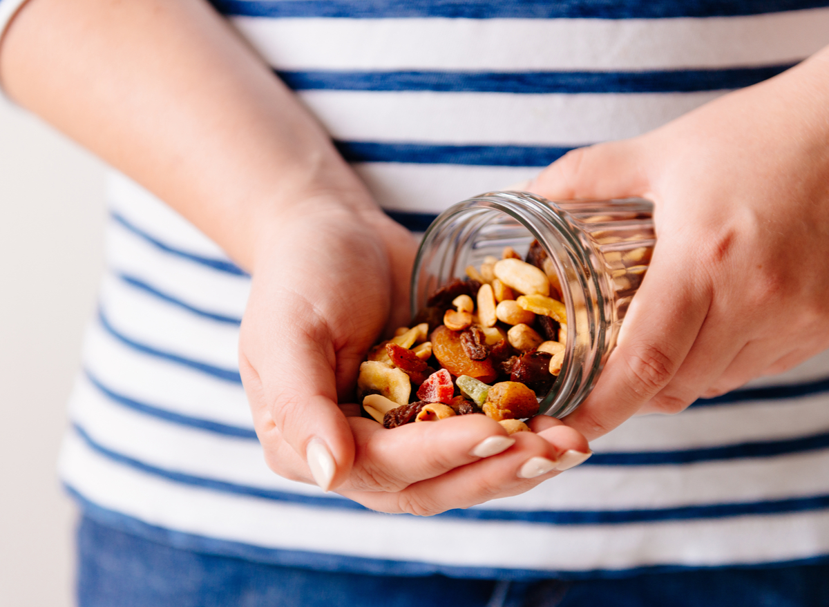 holding a jar of nuts and dried fruits