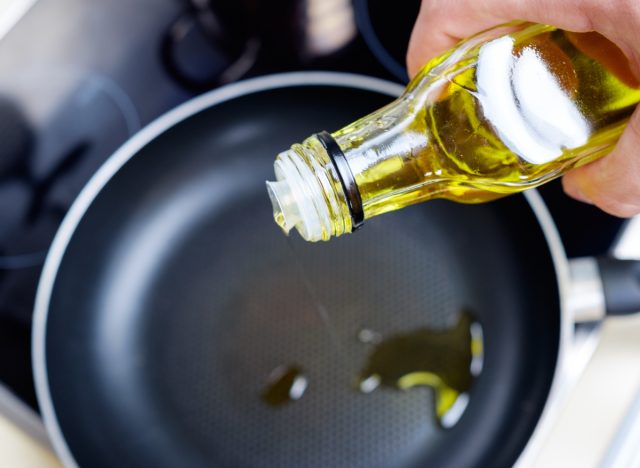 pouring olive oil into the pan