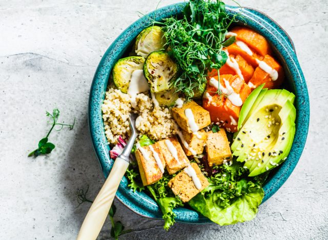bowl of tofu with vegetables, avocado and quinoa