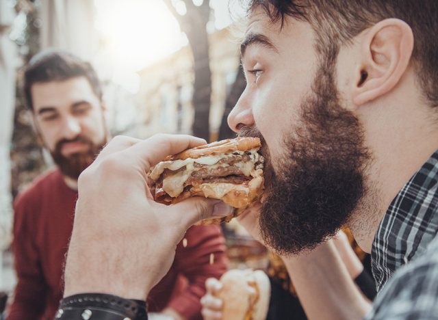 man eating a burger