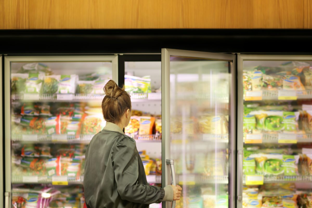 woman choosing frozen food at grocery store