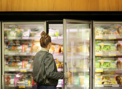 woman choosing frozen food at grocery store