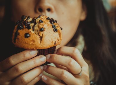 woman eating muffin