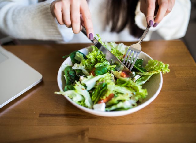 woman eating salad