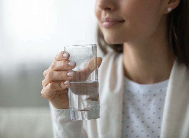 woman holding water glass