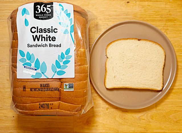 loaf of 365 white bread next to slice on a plate