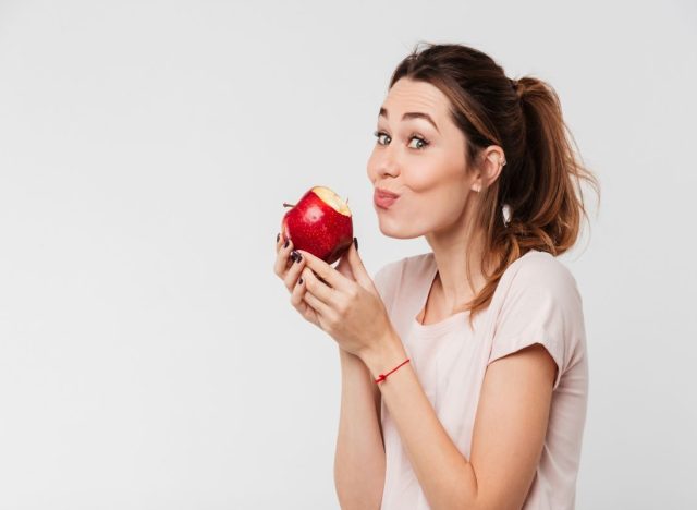 Woman Eating Red Apple