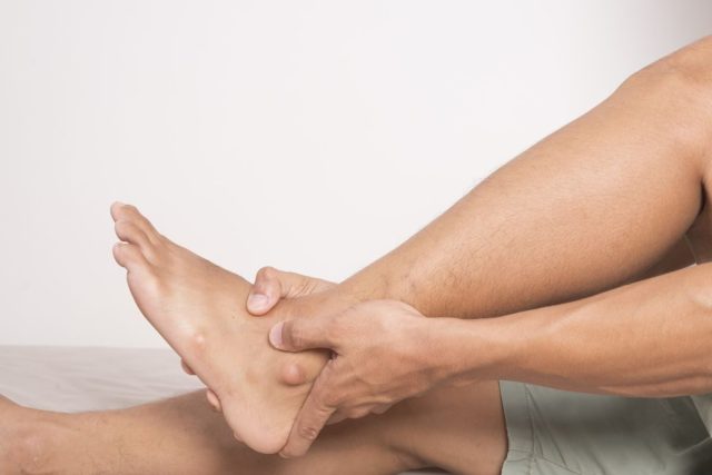 Holding on to ankle, bone fracture