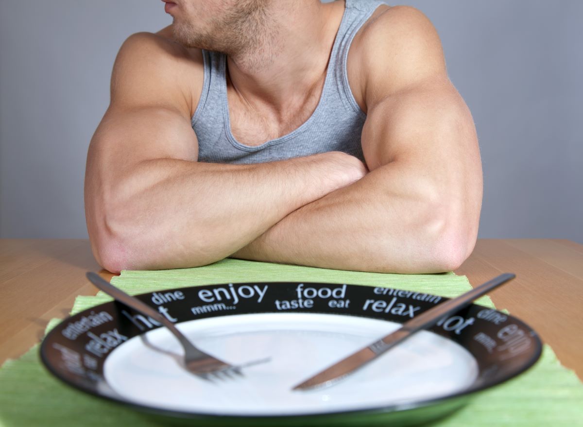 Man with muscles and empty plate