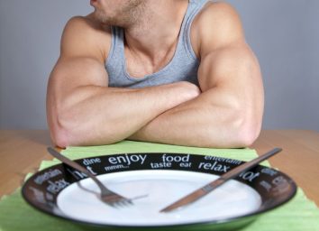 Man with muscles and empty plate