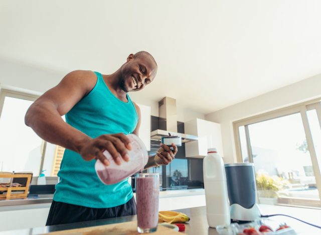 Guy makes smoothie for workout