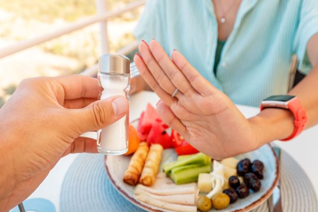 Woman Refusing Salt Shaker