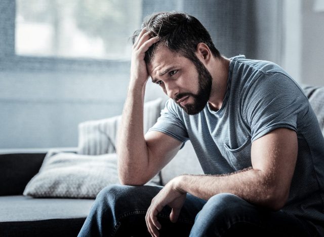 man stressed on couch