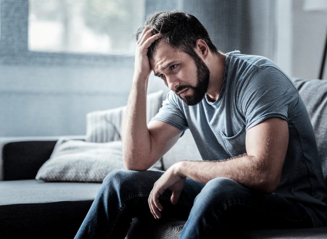 man stressed on couch