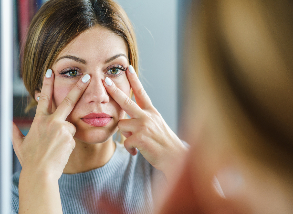 young woman doing face yoga exercise