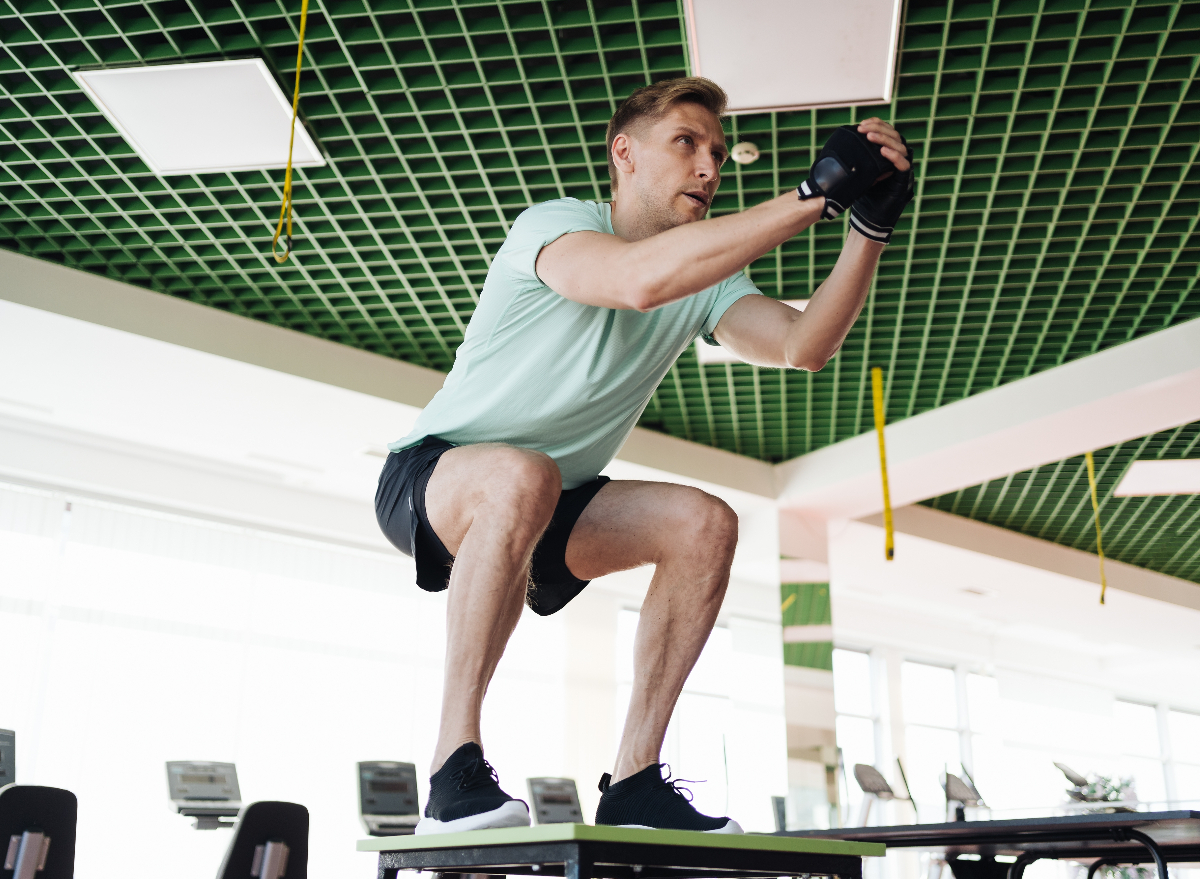 man doing jump squat